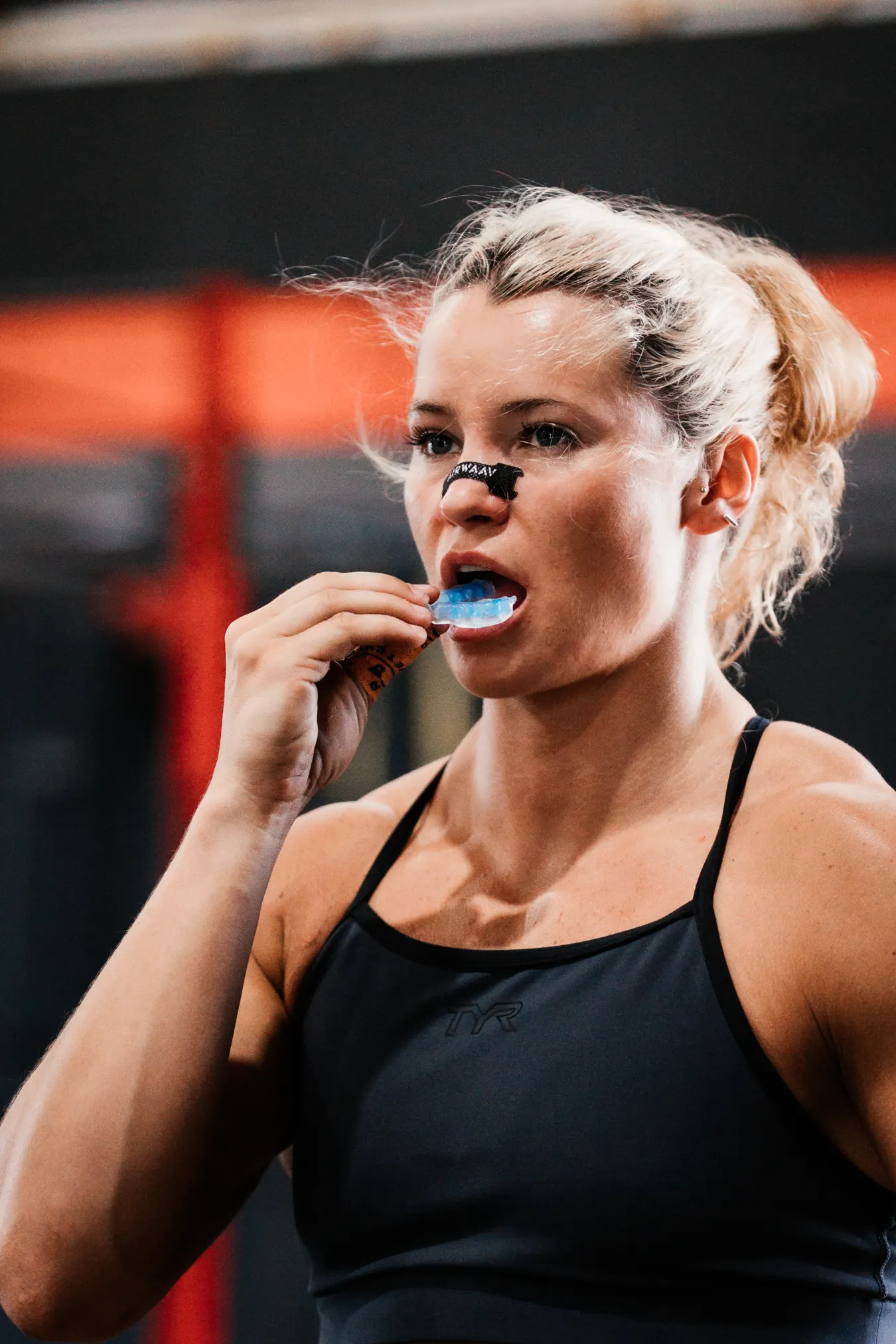 Female athlete using performance mouthpiece. 